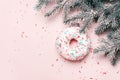 Christmas creative background. Christmas ball made of decorated donut and sugar sprinkling