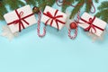 Christmas creative border with white and red decor, balls, gift, candy cane, snowflakes on blue background. Flat lay. Top view. Co Royalty Free Stock Photo