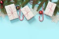 Christmas creative border with white and red decor, gifts, candy cane, snowflakes on blue background. Flat lay. Top view. Copy spa Royalty Free Stock Photo