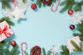 Christmas creative border with white snowflakes and branches on blue Flat lay. Top view. Copy space. Drawn snow. Royalty Free Stock Photo