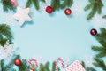 Christmas creative border with red balls, snowflakes and branches on blue background. Flat lay. Top view. Copy space. Royalty Free Stock Photo