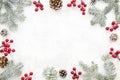 Christmas creative frame made of cones, red berry and fir branches on white background with free space for lettering Royalty Free Stock Photo