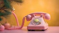 Christmas creative layout with old fashion pink telephone handsets with fir branch on pastel background. Royalty Free Stock Photo