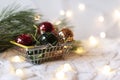 Christmas shopping basket on a white knitted background with red, green and gold christmas balls Royalty Free Stock Photo