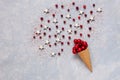 Christmas creativity concept with red balls, cranberry, stars in the waffle cone sprinkled with red sugar. Flat lay, Close-up