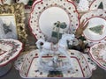Christmas crockery and flatware on display in a home decoration shop - plates, cups, Christmas toys, showcase in shop Royalty Free Stock Photo