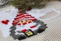 Christmas cross stitch designs and spruce. Preparing handmade gifts and decoration for New Year and Christmas