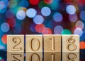 Christmas cubes on blurred blue background. Reflection. The new year 2018. Christmas Bokeh. Royalty Free Stock Photo