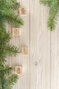 Christmas cubes on wooden background. New year mood. Spruce bran
