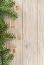 Christmas cubes on wooden background. New year mood. Spruce bran