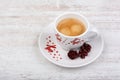 Christmas cup of espresso coffee on white wooden background