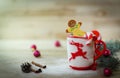 Christmas Cup ornament and a fun gingerbread on a wooden table Royalty Free Stock Photo