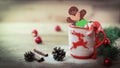 Christmas Cup ornament and a fun gingerbread on a wooden table Royalty Free Stock Photo