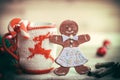 Christmas Cup ornament and a fun gingerbread on a wooden table Royalty Free Stock Photo