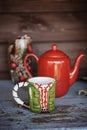 Christmas cup and red tea pot on wooden table Royalty Free Stock Photo