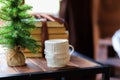 Christmas cup of tea and vintage books on wooden table over beautiful winter bokeh background with copy space - Image Royalty Free Stock Photo