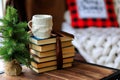 Christmas cup of tea and vintage books on wooden table over beautiful winter bokeh background with copy space - Image Royalty Free Stock Photo