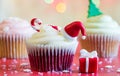 Christmas cupcake and holiday ornament on colorful defocused background