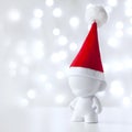 Christmas toy in Red Hat Santa Claus, Symbol New Year, Defocused Lights White Background Royalty Free Stock Photo