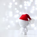 Christmas cute toy in Red Hat Santa Claus, Symbol New Year, Defocused Lights White Background Royalty Free Stock Photo