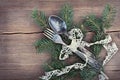 Christmas cutlery and fir tree on wooden background