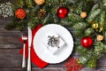 Christmas cutlery with a plate and a red napkin on a wooden background. New year and christmas concept. Royalty Free Stock Photo