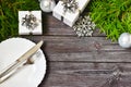 Christmas cutlery with a plate on a wooden background. New year and christmas concept. Royalty Free Stock Photo