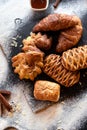 Christmas dark background with cup of coffee and croissants and bakery. New Year mood. Top view with special copyspace for text an