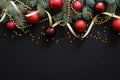 Christmas dark black background with red baubles, Christmas decorations, fir tree branches, confetti star. Xmas frame border, top
