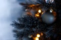 Christmas dark blurred background with a black Christmas tree, ornaments and bokeh lights Royalty Free Stock Photo