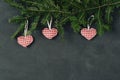 Christmas dark holiday background, natural decorations set in a composition with hand made toy red hearts, spruce branches Royalty Free Stock Photo