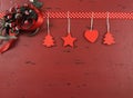 Christmas dark red vintage recycled wood background with hanging wood ornaments - horizontal Royalty Free Stock Photo