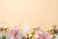 Christmas Day concept. Top view photo of gift boxes with ribbon bows gold and pink baubles snowflake ornaments pine branches in Royalty Free Stock Photo