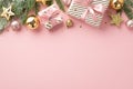 Christmas Day concept. Top view photo of stylish gift boxes with ribbon bows spruce branches in snow gold pink baubles balls and Royalty Free Stock Photo
