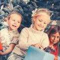 Christmas day in family, the Children unwrapping presents Royalty Free Stock Photo