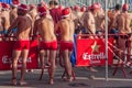 CHRISTMAS DAY HARBOUR SWIM 2015, BARCELONA, Port Vell - 25th December: Swimmers in Santa Claus hats prepared for contest Royalty Free Stock Photo