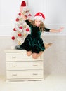 It is christmas. Day we have waited for all year finally here. Girl excited about christmas jump mid air. Child