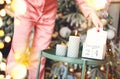 Christmas day. Woman in pajama flipping wooden calendar from 24 to 25 december in morning