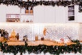 Christmas decor with a garland in the white kitchen Royalty Free Stock Photo