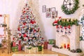 Christmas decor of the living room . the decoration of the room. Christmas snow-covered fir tree with toys. gift boxes under the Royalty Free Stock Photo