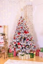 Christmas decor of the living room . the decoration of the room. Christmas snow-covered fir tree with toys. gift boxes under the Royalty Free Stock Photo