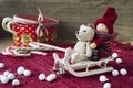 Christmas decor - miniature toys on sledges. Gift box with candies.