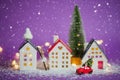 Christmas decor - red retro car on snow carries past houses with fairy lights in bokeh Christmas tree with gift boxes on roof. Toy Royalty Free Stock Photo