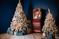 Christmas decor in a room with blue walls, two Christmas trees decorated with toys and lights, Royalty Free Stock Photo