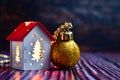 Christmas decor. Small Christmas house with glowing windows from the inside. toy in the form of house with illuminated windows Royalty Free Stock Photo