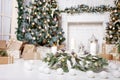 Christmas decor. Christmas tree decorations and holiday homes. New Year`s interior with a fir tree in white tones