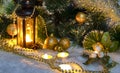 Christmas decor decorated pine branches and burning wax candles on the snow