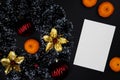 Christmas decor and white paper card on black background. Blank card with text place. Christmas wreath top view Royalty Free Stock Photo
