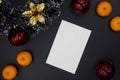 Christmas decor and white paper card on black background. Vertical blank card. Christmas composition top view Royalty Free Stock Photo