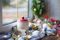 Christmas decor by the window on a cozy wooden windowsill with a mug with a drink and a cookie jar. Fairy lights, Christmas tree